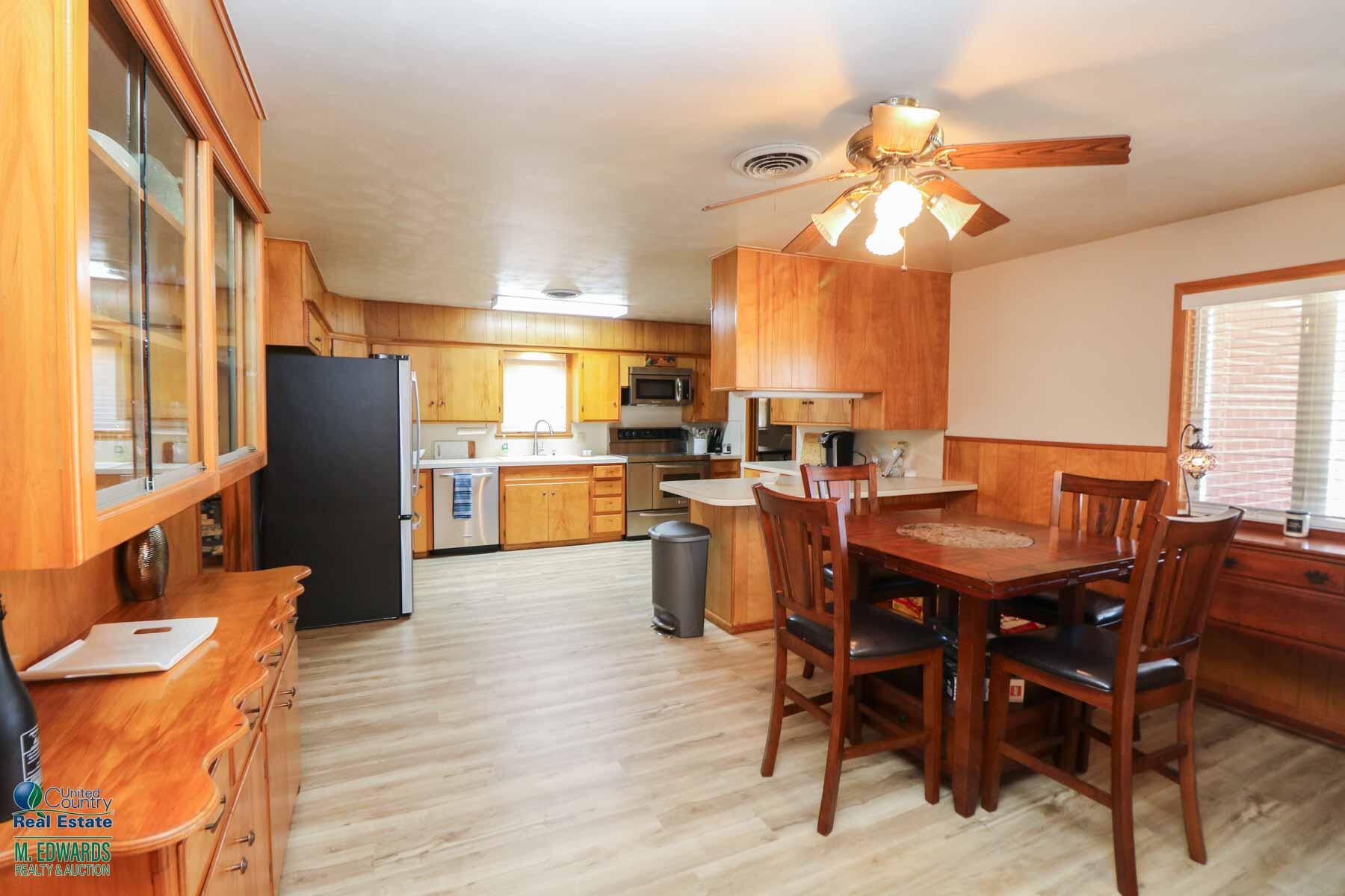 312 East 18th Street Littlefield, TX 79339 - Photo 5 of 14 a view of a dining room with furniture window and wooden floor