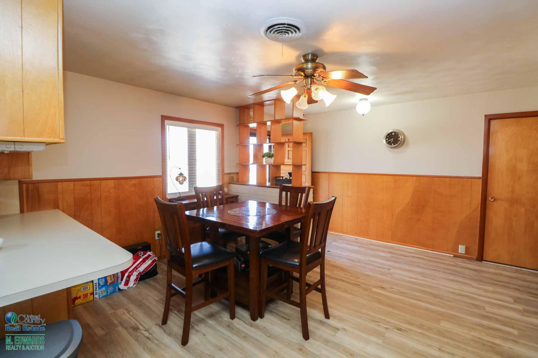 312 East 18th Street Littlefield, TX 79339 - Photo 6 of 14 a view of a dining room with furniture and wooden floor