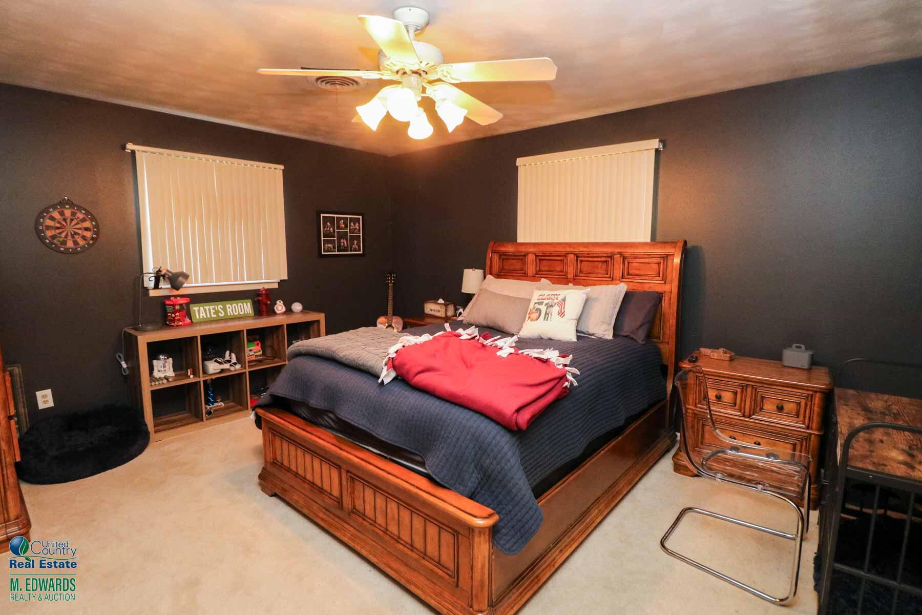 312 East 18th Street Littlefield, TX 79339 - Photo 10 of 14 a bed room with a bed and a chandelier