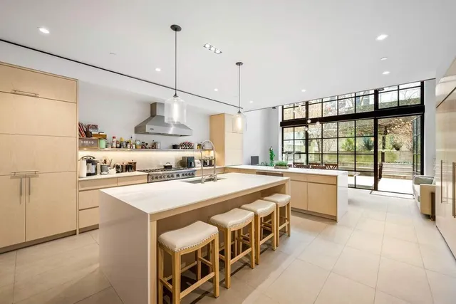a open kitchen with stainless steel appliances granite countertop a sink a stove and a refrigerator