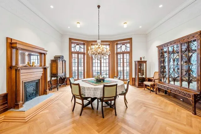 a dining room with furniture window fireplace and wooden floor