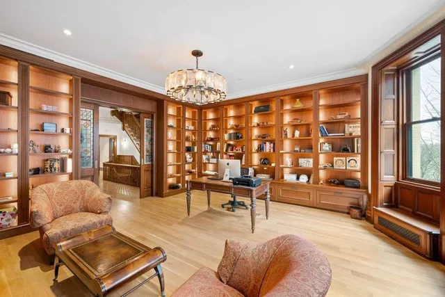 a living room with furniture a chandelier and a large window