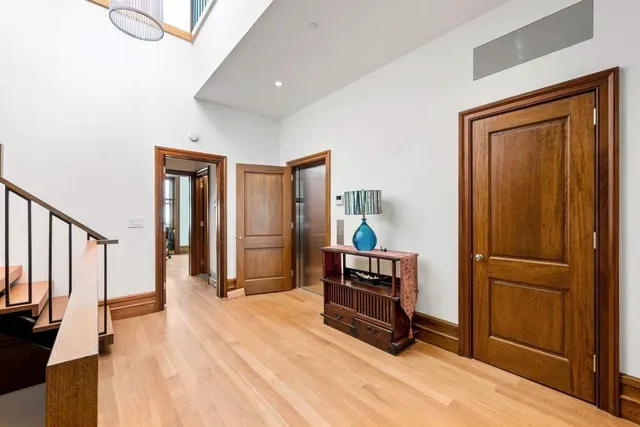 a view of kitchen with stainless steel appliances wooden floor and chair