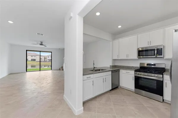 a kitchen with stainless steel appliances granite countertop a stove and a sink