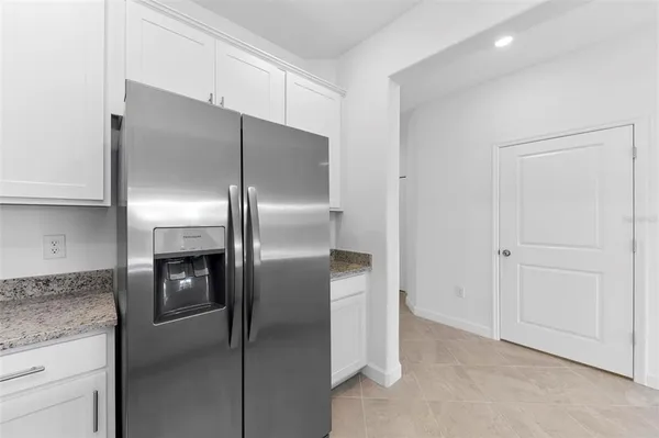 a metallic refrigerator freezer and a dishwasher in a kitchen