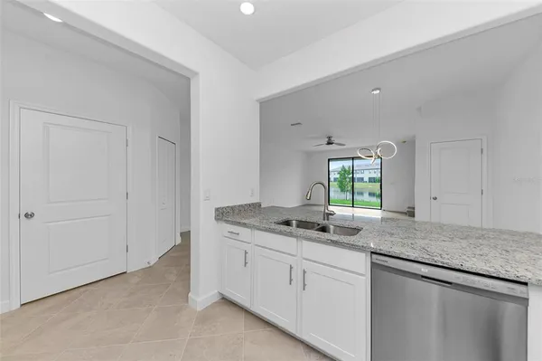 a bathroom with a granite countertop sink and mirror