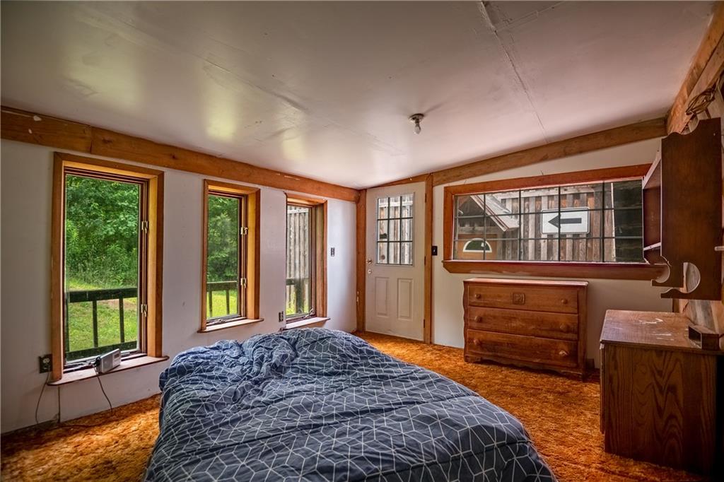 2738 Valley Road Mercer, PA 16137 - Photo 9 of 27 a bedroom with a bed and a dresser next to a window