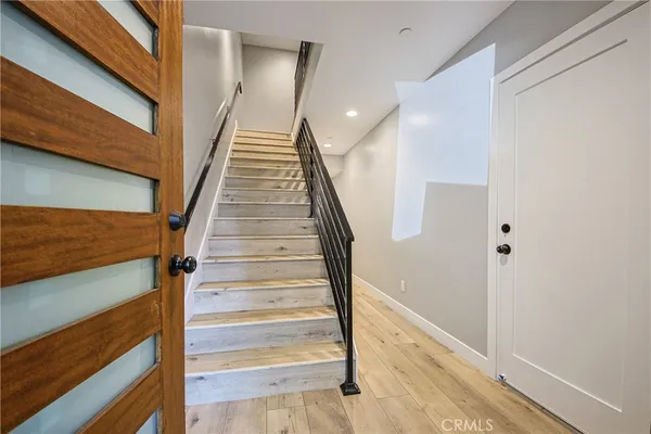 a view of staircase with white walls and railing
