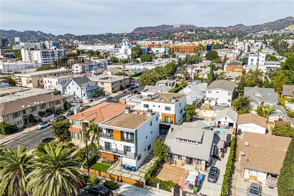 an aerial view of residential houses with city view