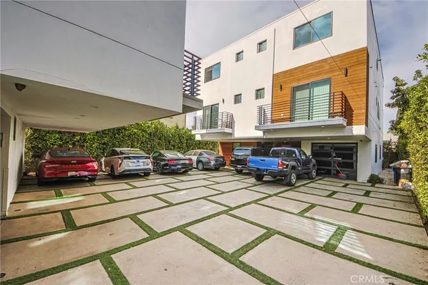a view of a cars park in front of building