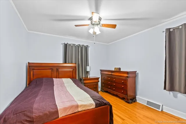 a bedroom with furniture and wooden floor