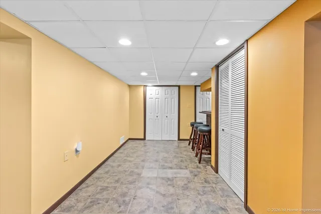 a view of a hallway with closet and wooden floor