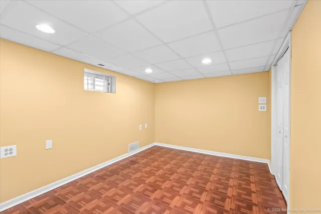 a view of a house with a yard and large trees