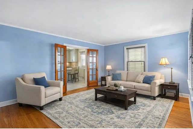 a living room with furniture and wooden floor
