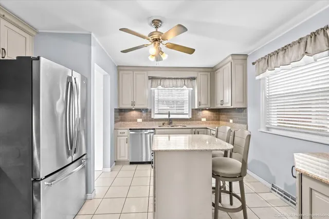 a kitchen with stainless steel appliances a refrigerator sink and cabinets