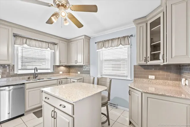 a kitchen with a sink a stove and cabinets