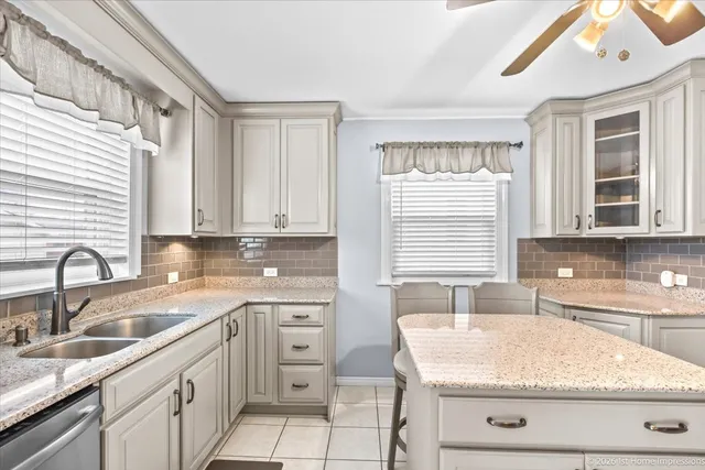 a kitchen with granite countertop a sink stainless steel appliances and cabinets