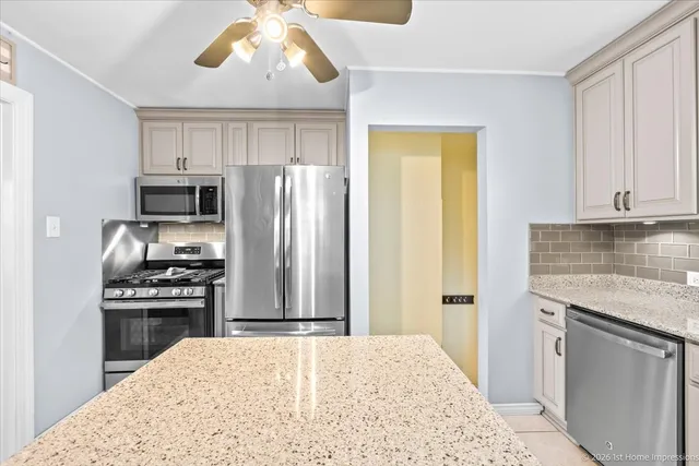 a kitchen with a stove a refrigerator and a sink