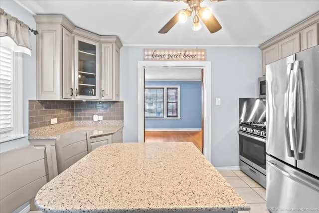 a kitchen with stainless steel appliances granite countertop a refrigerator and a sink