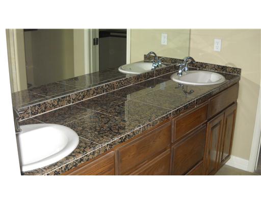 4750 Grand Junction Drive, Unit 28 Corpus Christi, TX 78413 - Photo 4 of 6 a bathroom with a sink and a mirror