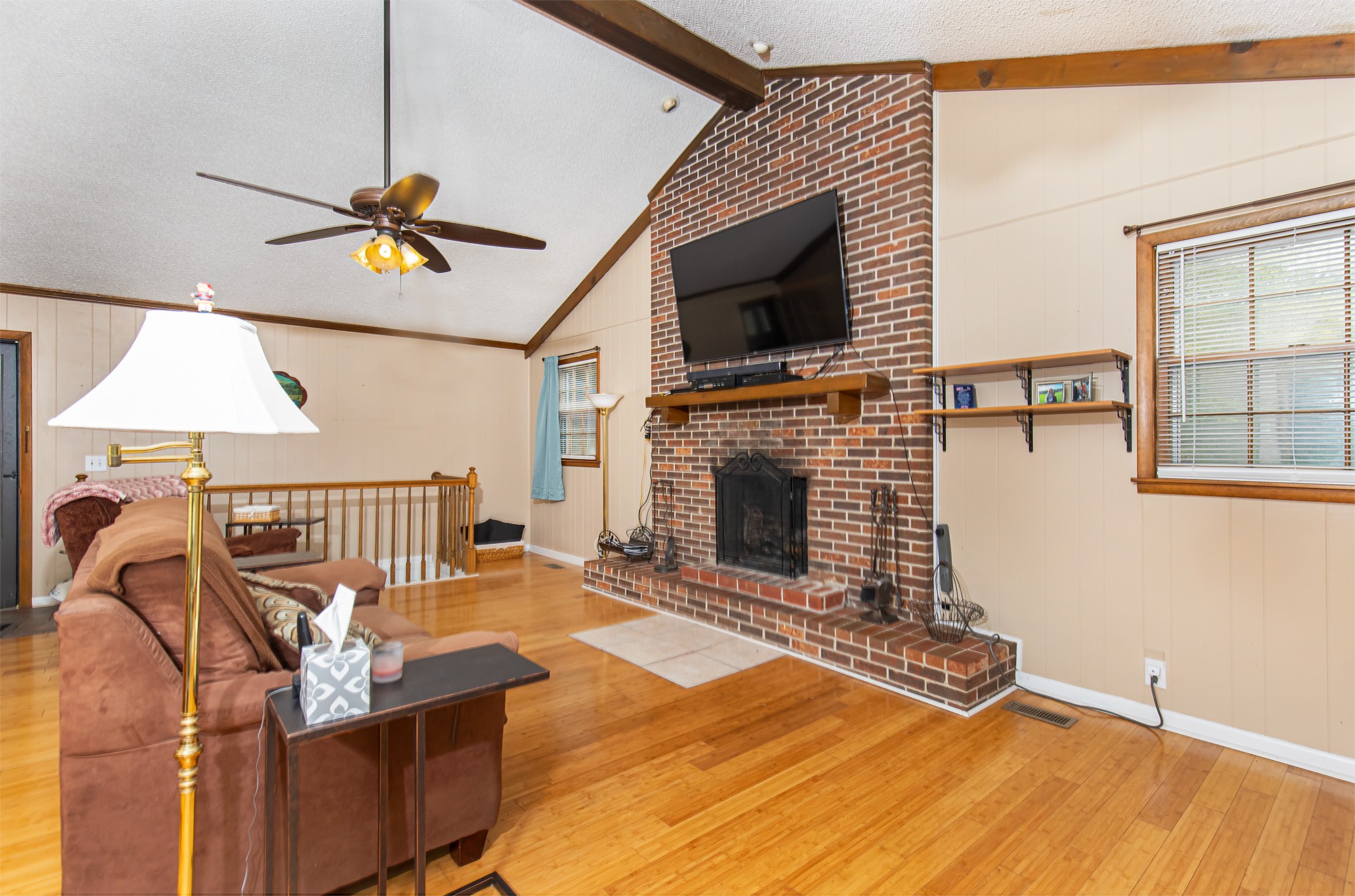 a living room with furniture a flat screen tv and a fireplace