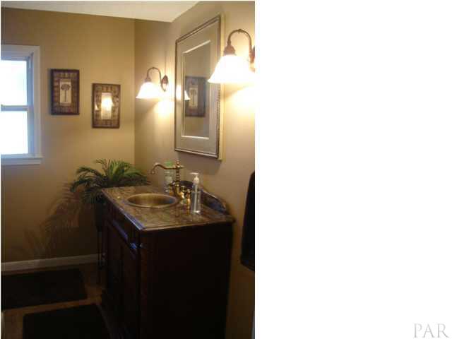 3960 McClellan Road Pensacola, FL 32503 - Photo 14 of 24 Half bathroom downstairs between living room and kitchen