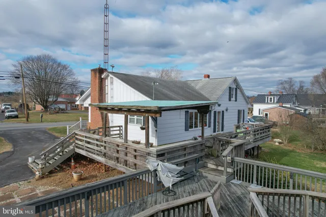 a view of a house with wooden deck
