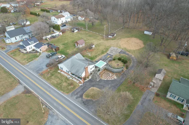 an aerial view of a house with a garden and a lake view