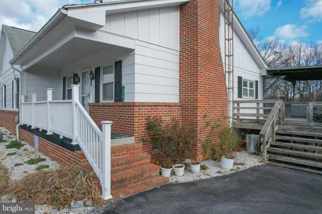a view of a house with a yard and stairs