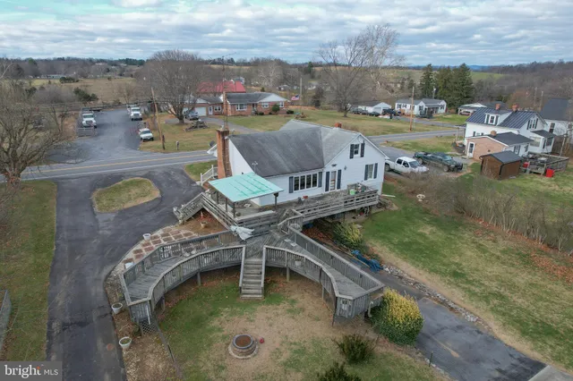 a view of a house with pool and sitting area