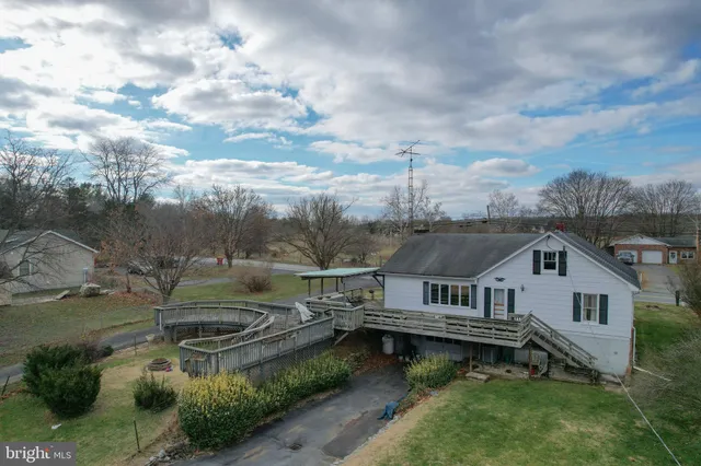an aerial view of a house with swimming pool and mountains
