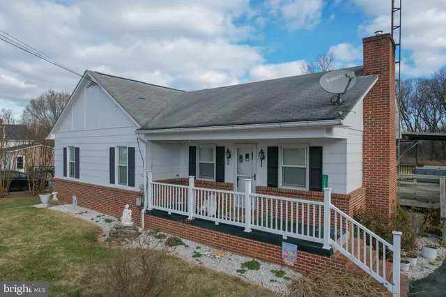 a view of a house with wooden fence