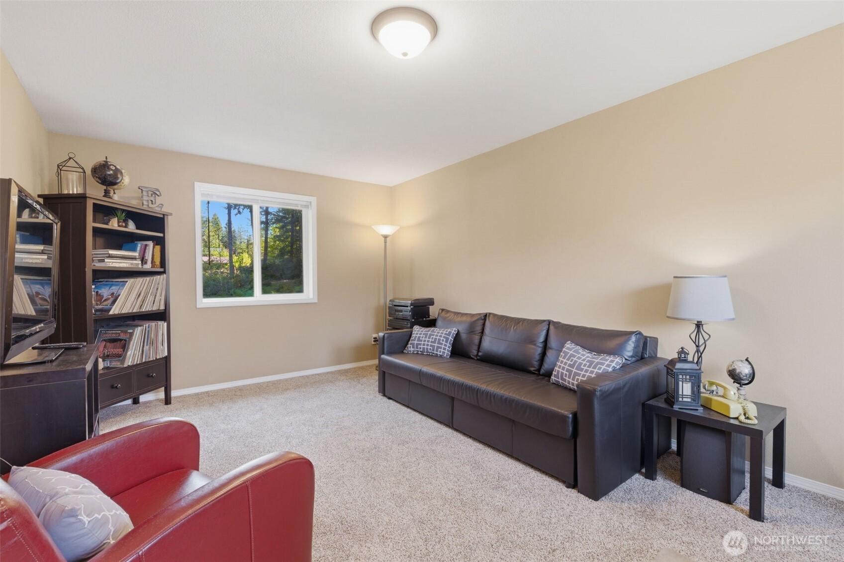 6971 Northeast Tahuya Blacksmith Road Belfair, WA 98528 - Photo 29 of 38 a living room with furniture a flat screen tv and a window