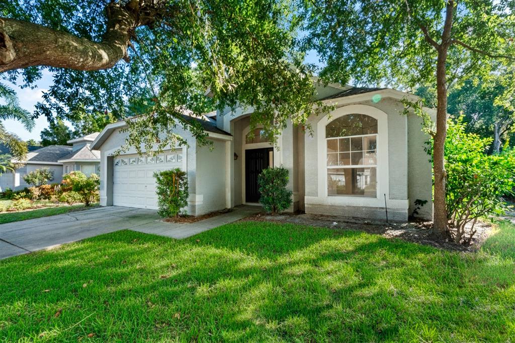 608 Bridge Creek Boulevard Ocoee, FL 34761 - Photo 1 of 17 a front view of a house with a yard and garage