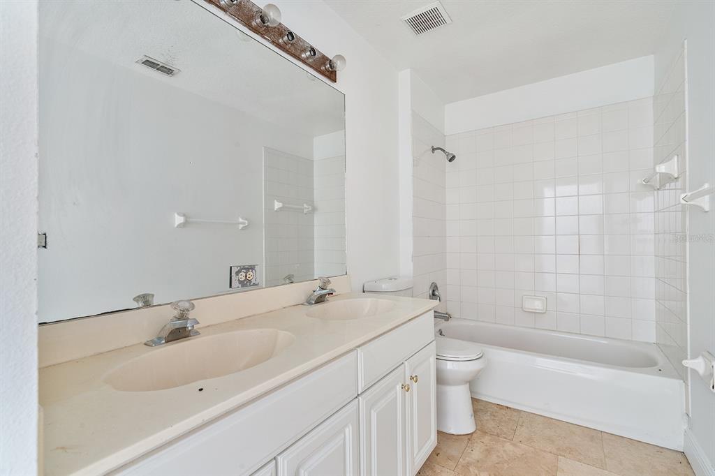 608 Bridge Creek Boulevard Ocoee, FL 34761 - Photo 13 of 17 a bathroom with a bathtub shower sink mirror and toilet