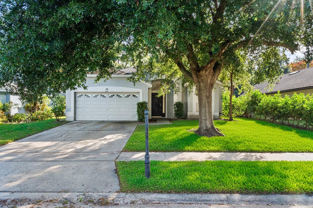 608 Bridge Creek Boulevard Ocoee, FL 34761 - Photo 2 of 17 a front view of a house with a yard and a garage