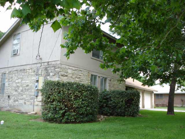 a view of a white house with a tree