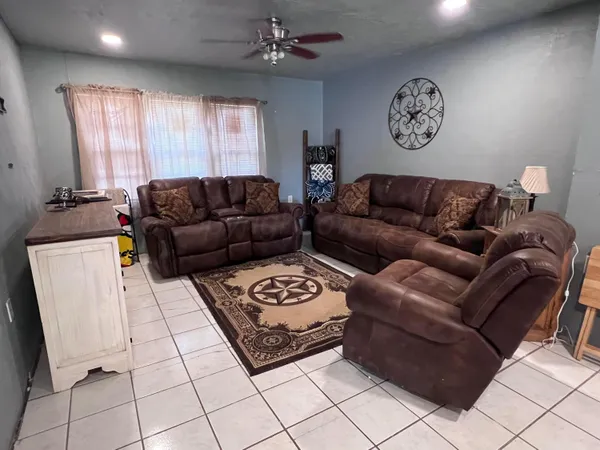 a living room with furniture a window and a table