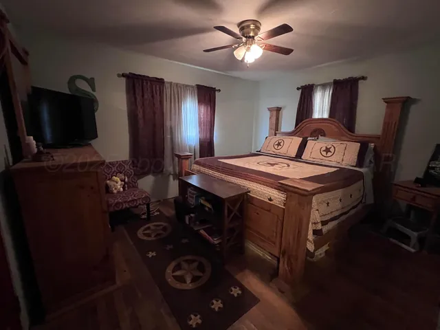 a bedroom with a bed and a television in it