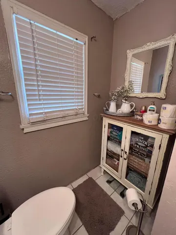 a bathroom with a toilet a sink and a mirror