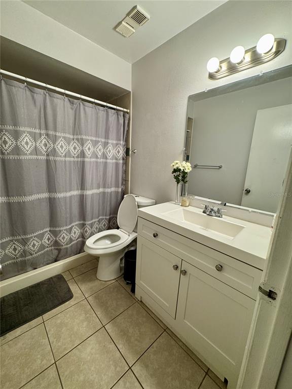 2379 Flamingo Way Winter Park, FL 32792 - Photo 6 of 25 a bathroom with a toilet sink and mirror