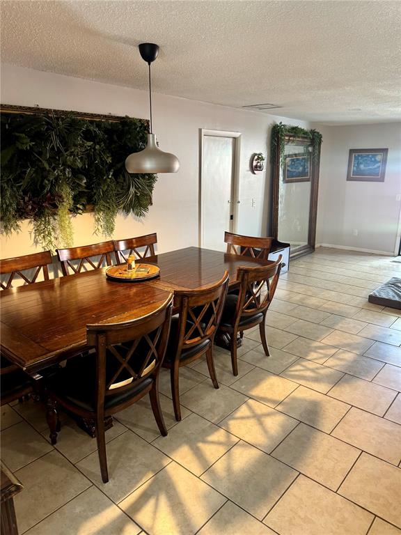 2379 Flamingo Way Winter Park, FL 32792 - Photo 8 of 25 a dining room with furniture and a chandelier
