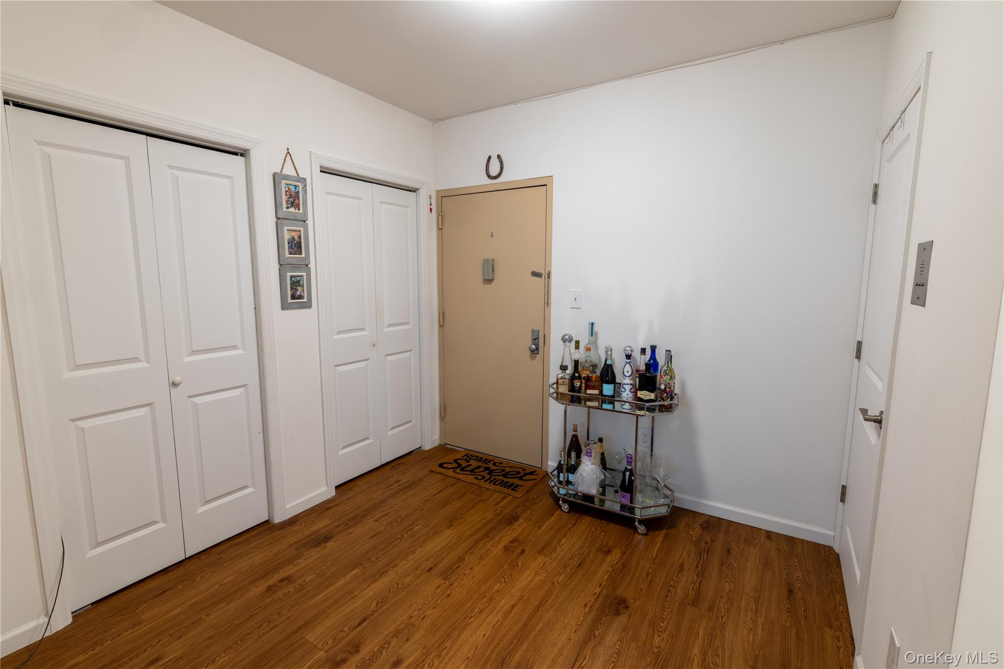 525 Beach 138th Street, Unit A2 Queens, NY 11694 - Photo 2 of 12 an empty room with wooden floor and a window
