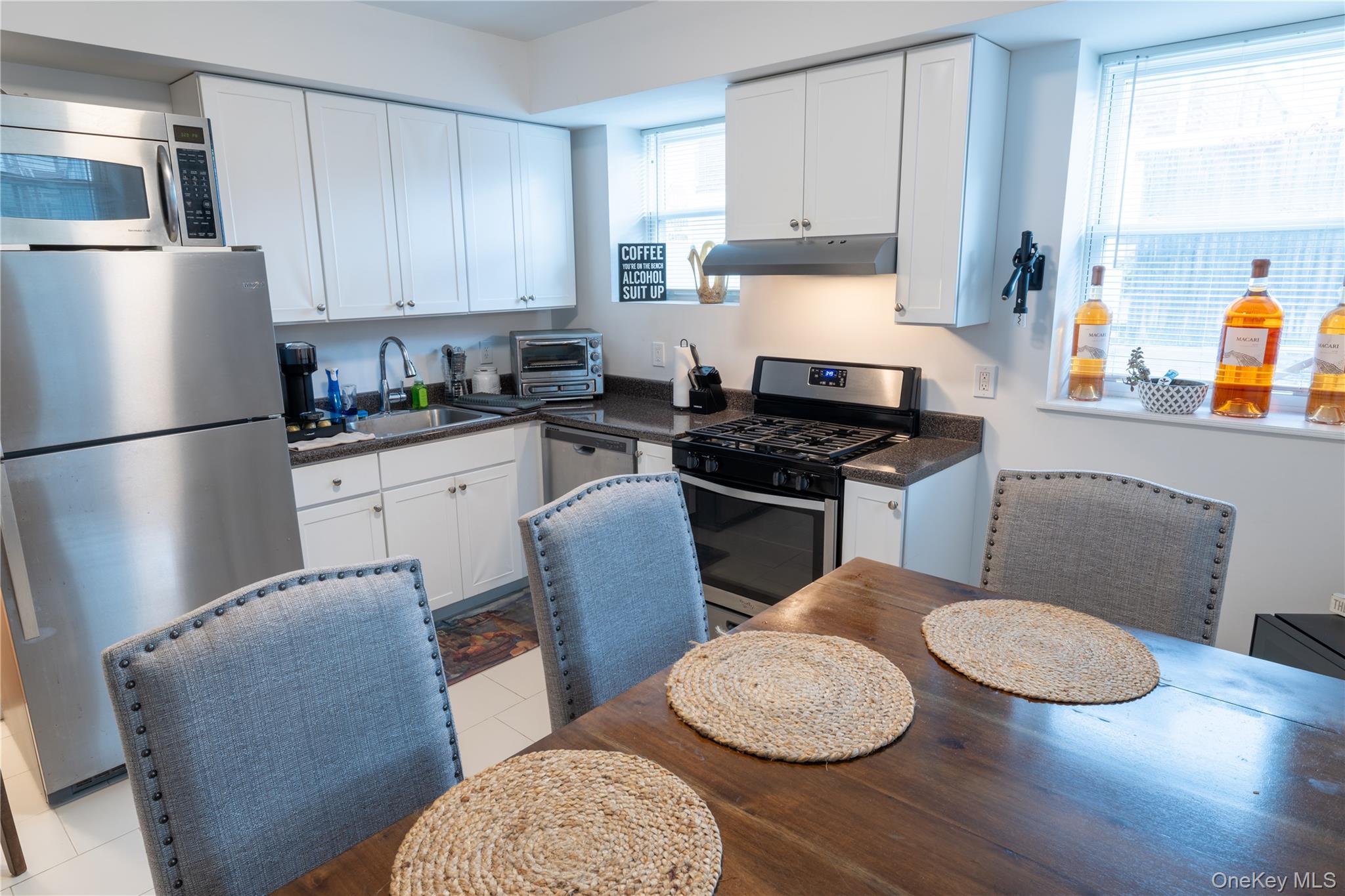 525 Beach 138th Street, Unit A2 Queens, NY 11694 - Photo 8 of 12 a kitchen with stainless steel appliances a sink a stove a refrigerator and cabinets