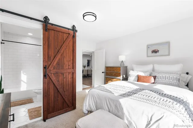 a bedroom with a bed and a mirror