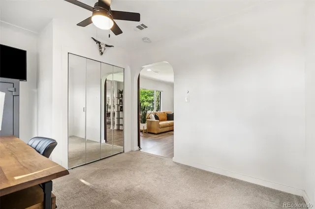 a view of a livingroom with furniture and a ceiling fan