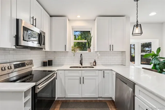 a kitchen with a sink stove and microwave