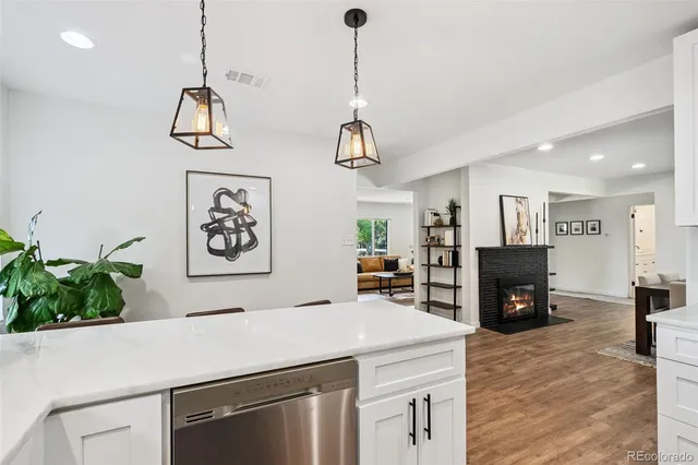 a room with kitchen island a counter top space and wooden floor