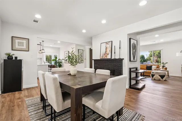 a living room with furniture a fireplace and a table