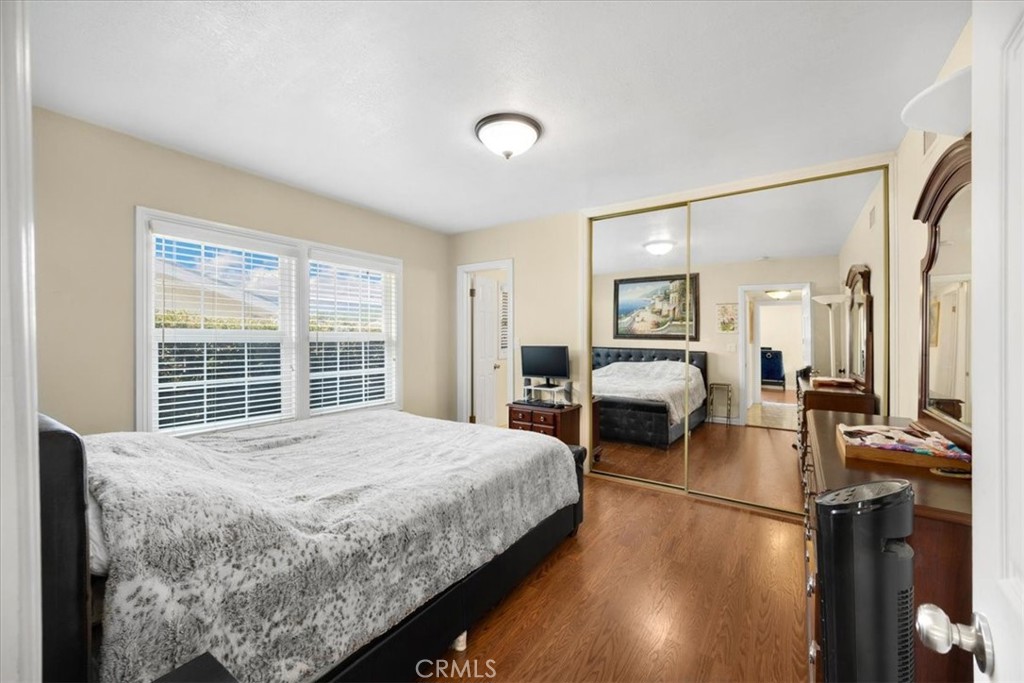 2183 Sinclair Street Pomona, CA 91767 - Photo 33 of 38 a bedroom with a bed couch and a large window